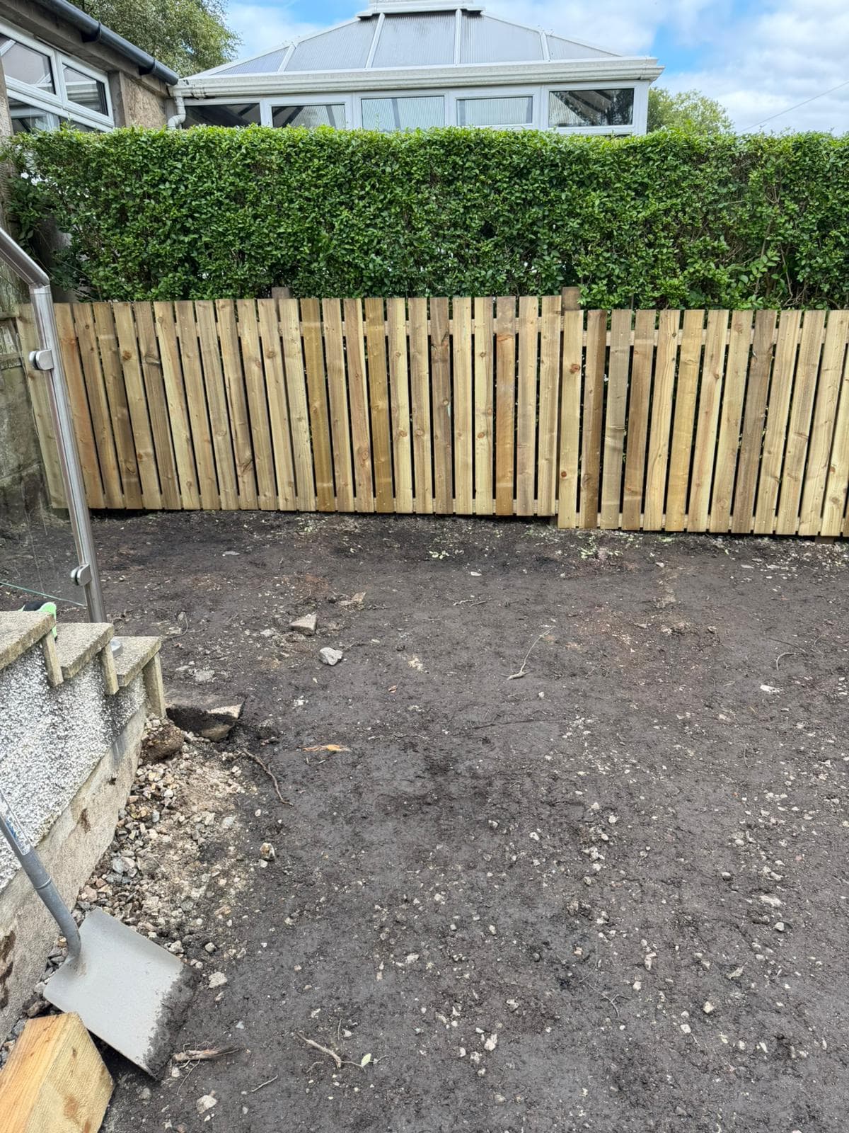 New close-board fencing running along the rear garden boundary during the rebuild