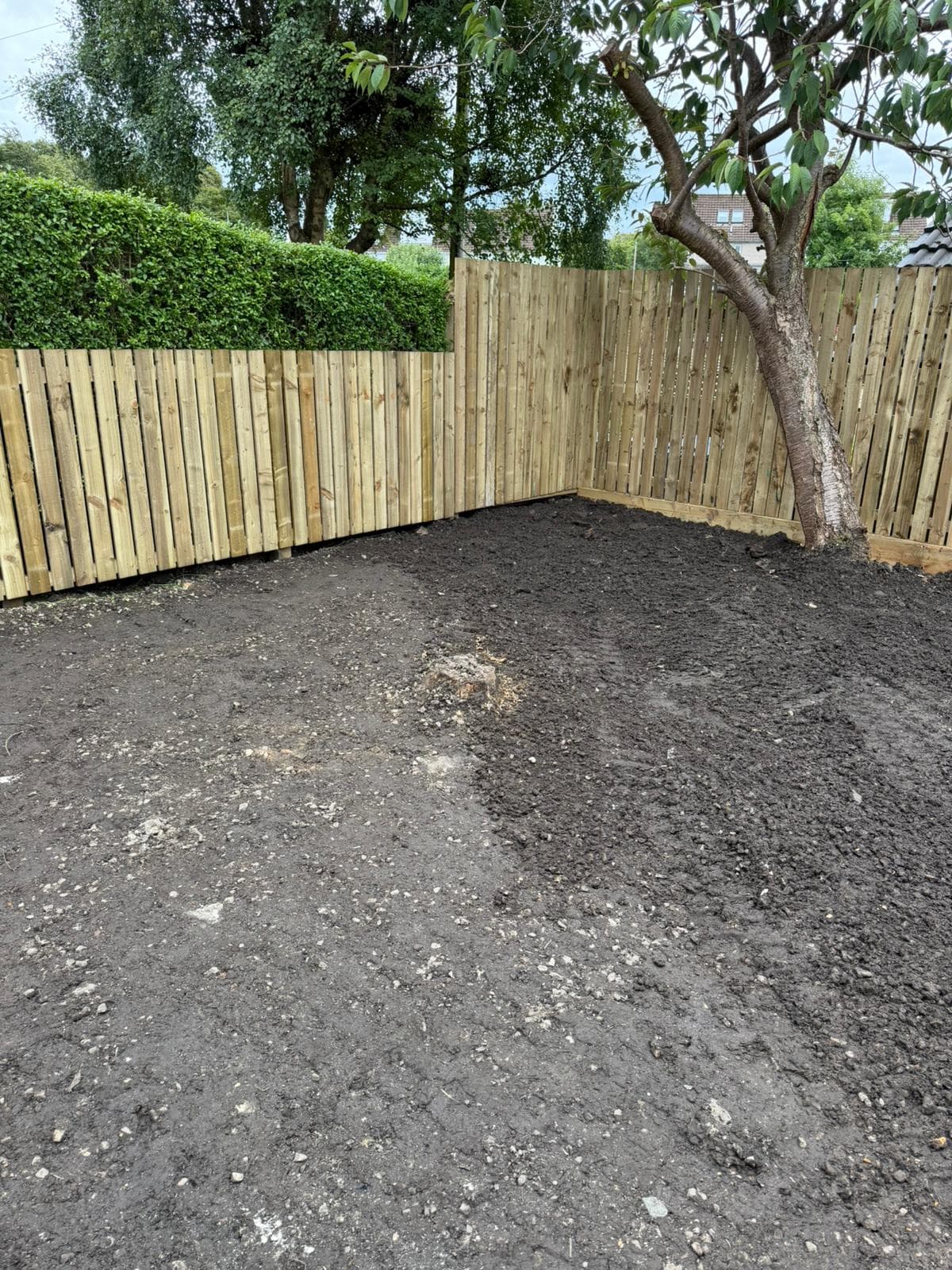 Rebuilt timber boundary running the length of a rear garden