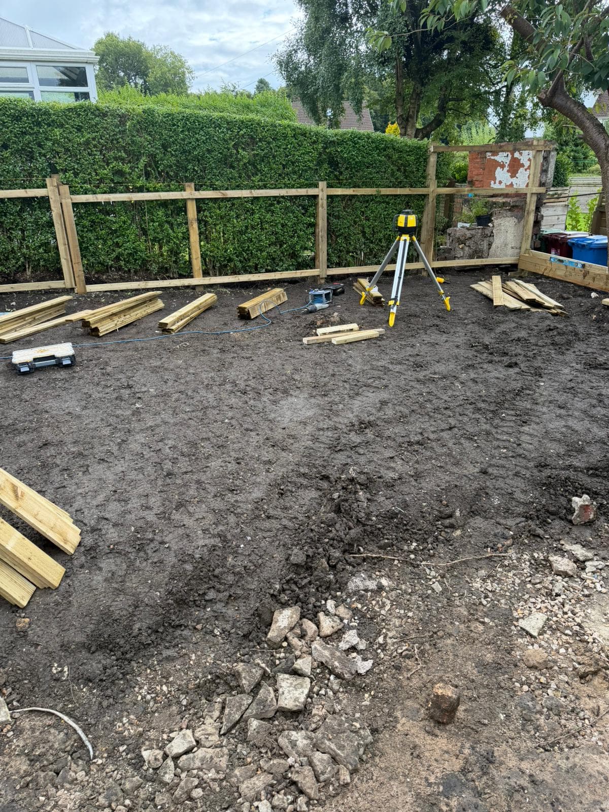 Rear garden cleared to bare soil at the start of a full rebuild