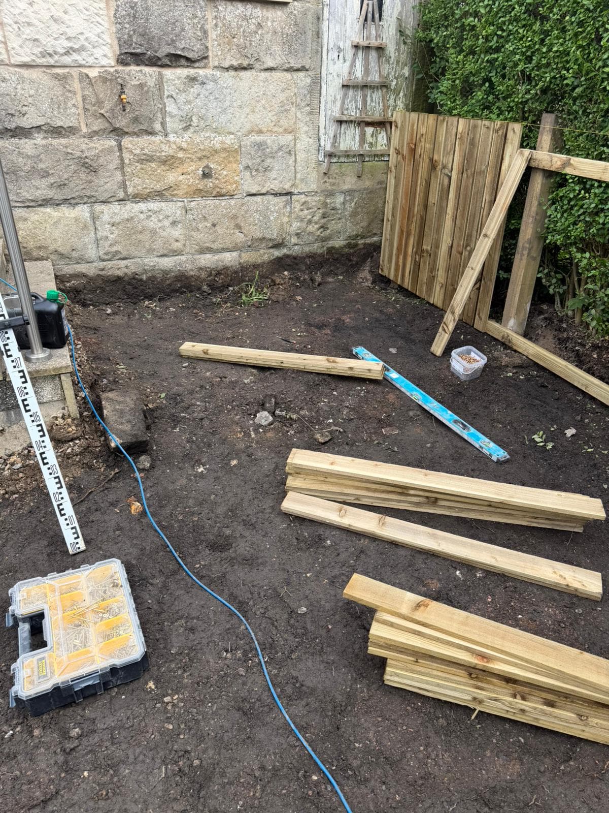 Levels being set across a cleared rear garden before hard landscaping begins