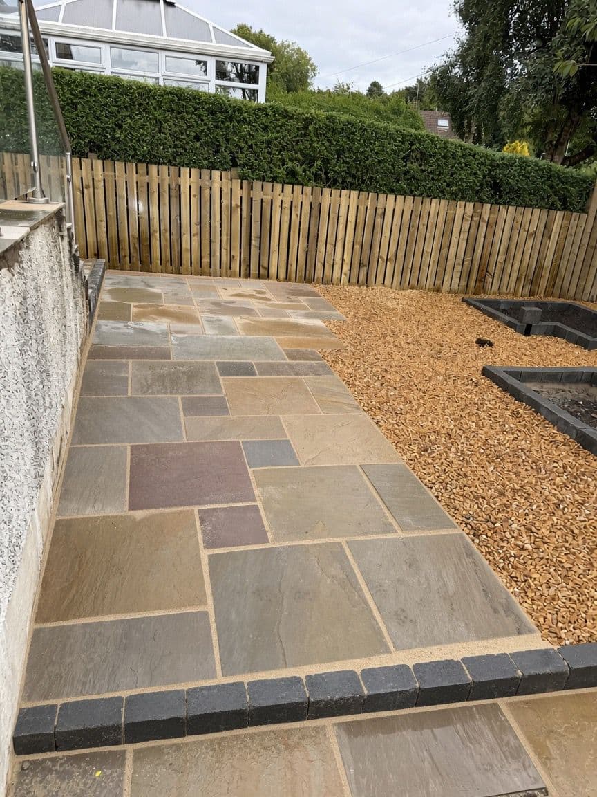 Multi-tone sandstone patio paving detail in a finished garden