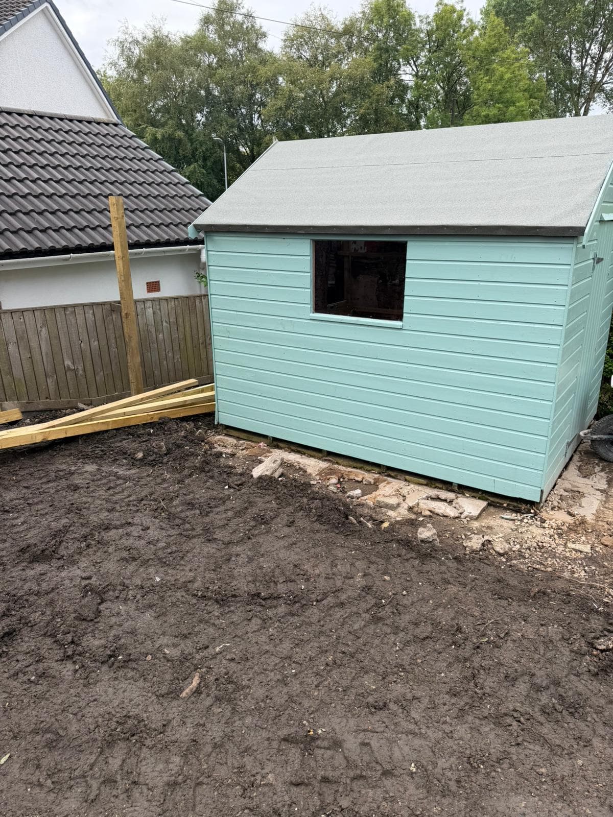 Cleared outdoor space ready for landscaping, with ground cleared and boundary fencing renewed